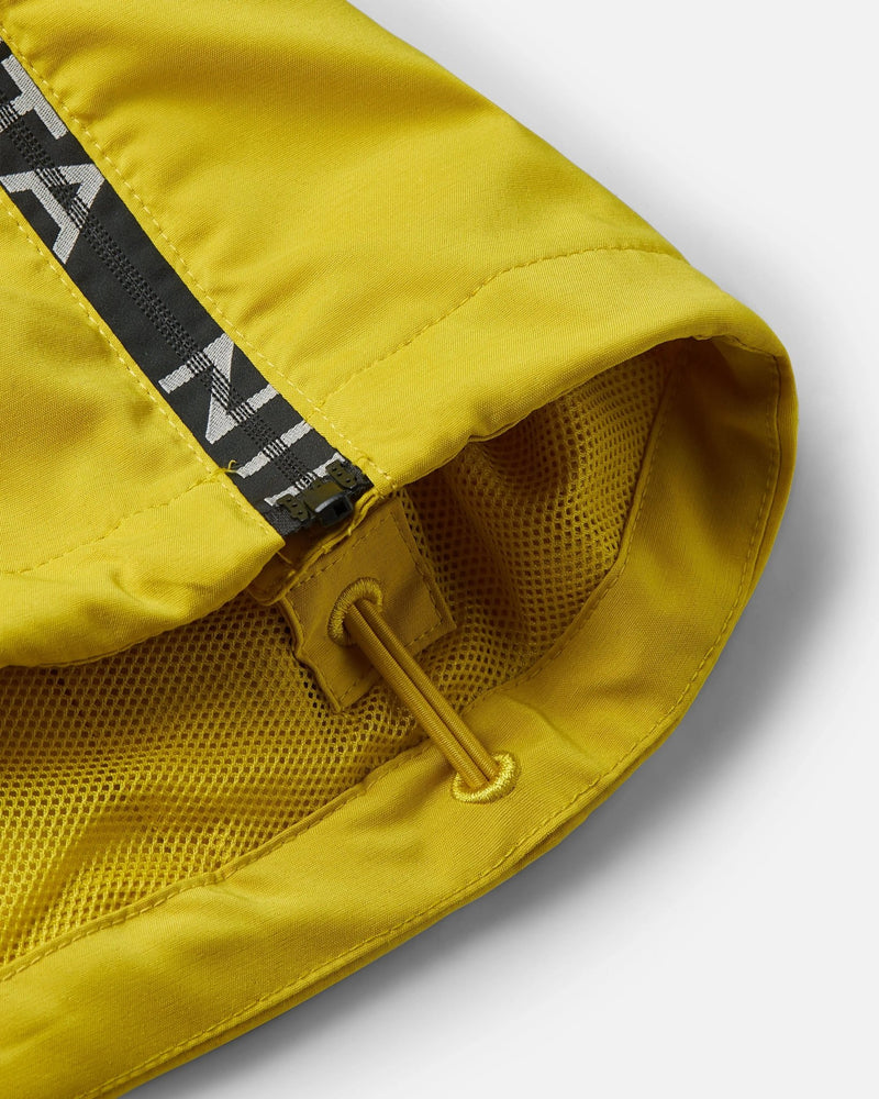 Close-up of the saffron quartz Nike x Patta track jacket highlighting the yellow mesh lining and drawstring.