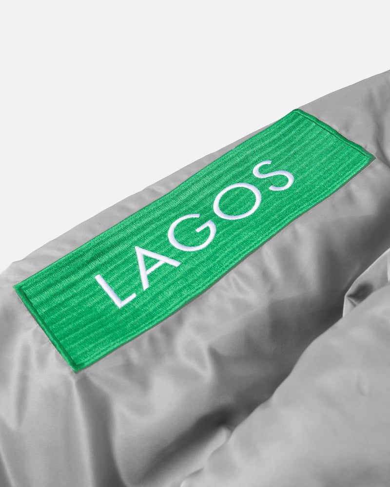 Embroidered green Lagos patch on the silver Patta x Alpha Industries MA-1 Celebration jacket sleeve.