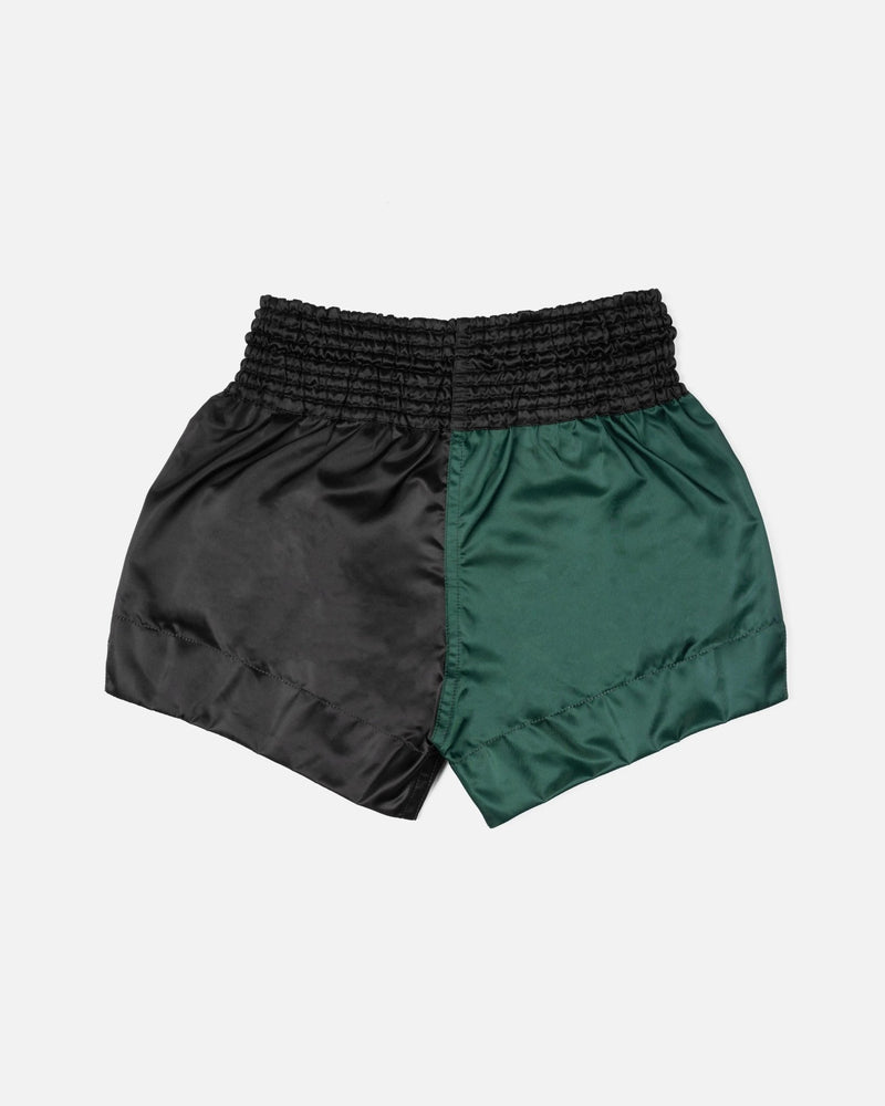 Back view of Patta x Fairtex Homecoming 2025 Muay Thai shorts in split black and green satin.