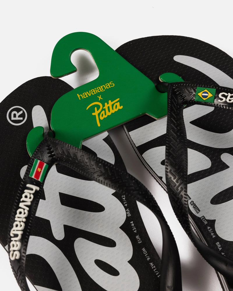 Patta x Havaianas black flip-flops with green co-branded hanger and graphic footbed.