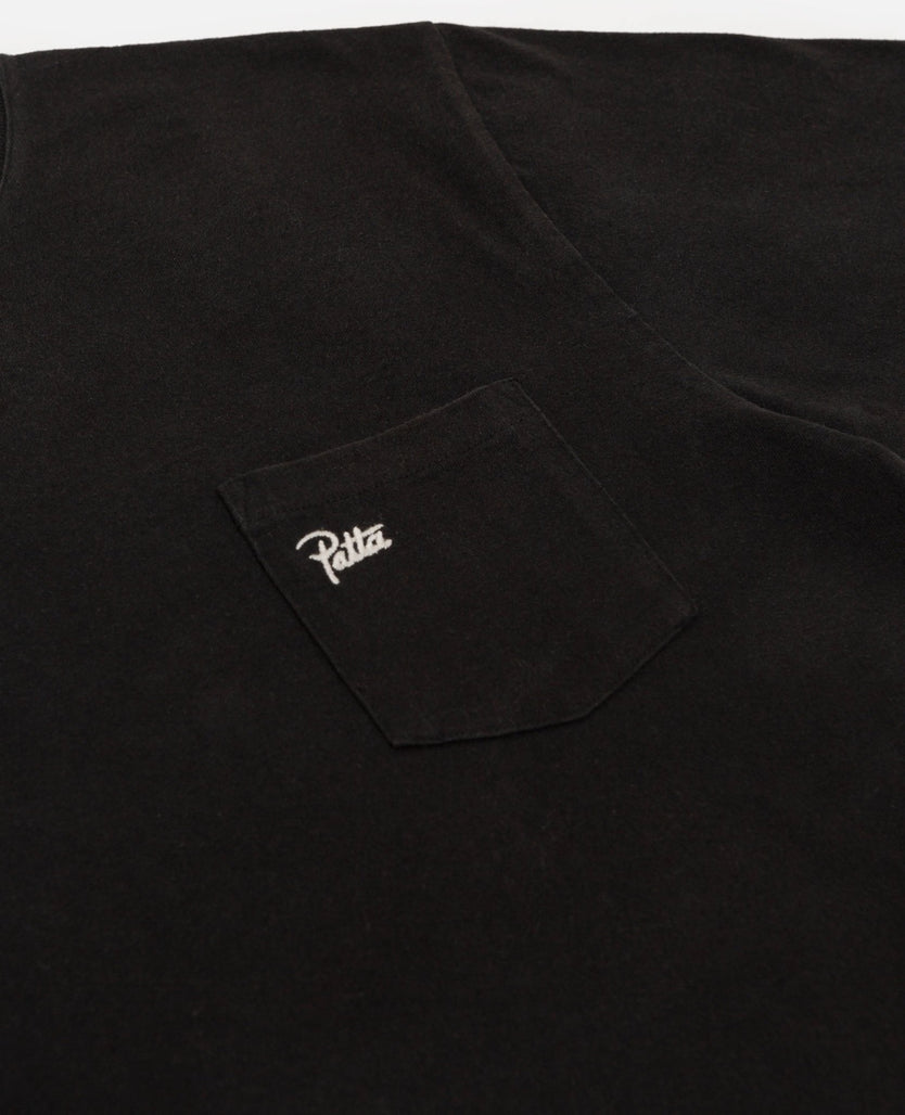Close-up of the chest pocket with embroidered Patta script logo on a black washed pocket t-shirt.