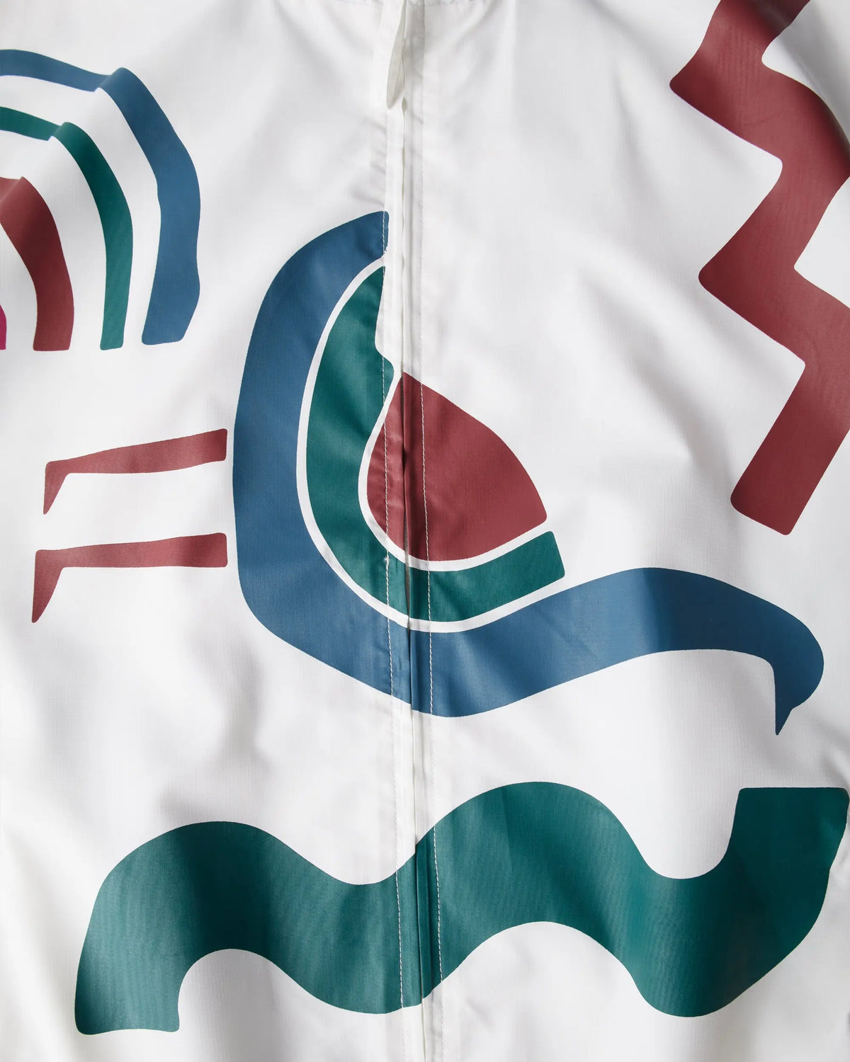 Close-up of the white byParra Tennis Maybe? Track Jacket featuring colorful abstract graphic prints.
