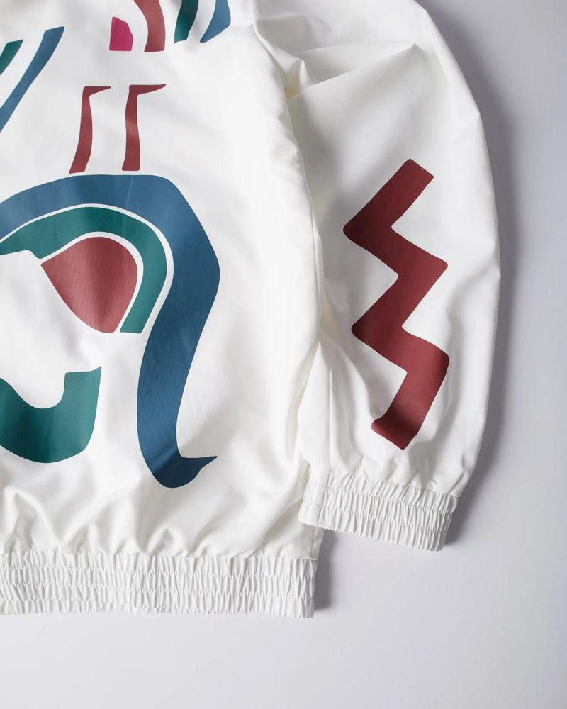 Close-up of the white byParra Tennis Maybe? Track Jacket with abstract artwork and elasticated cuffs.