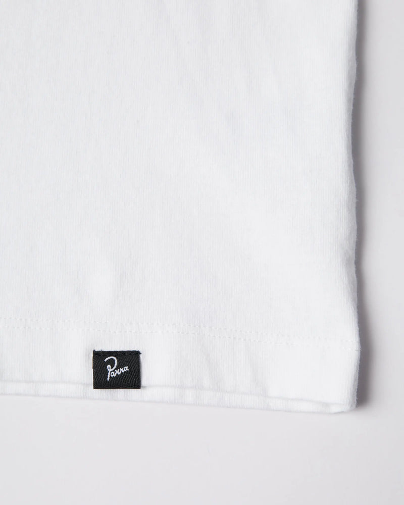 Close-up of the woven Parra logo tag on the hem of the white ByParra Our House T-shirt.