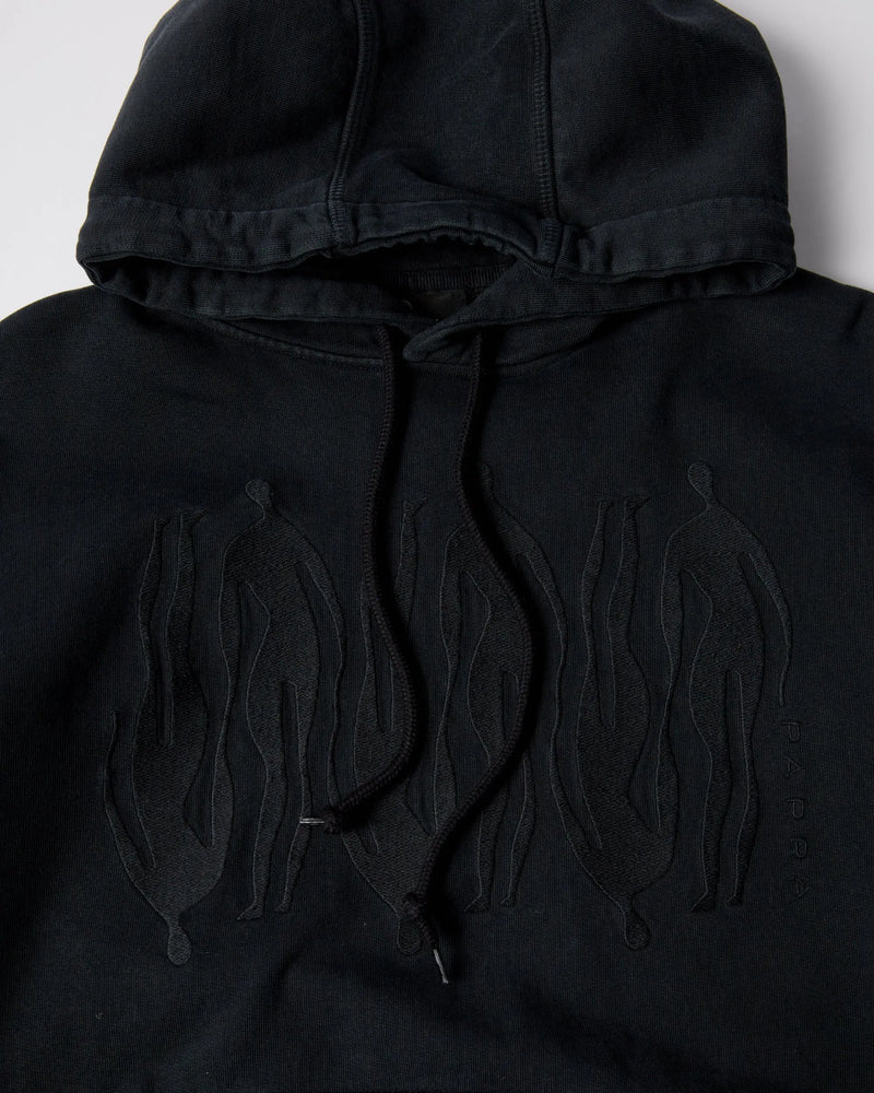 Close-up of the black ByParra Connected Guy hoodie featuring tonal figure embroidery on the chest.