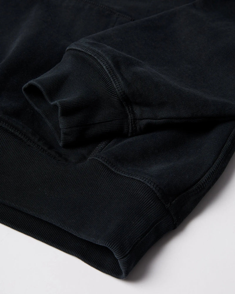 Close-up of the ribbed cuff and hem on the black ByParra Connected Guy Hooded Sweatshirt.