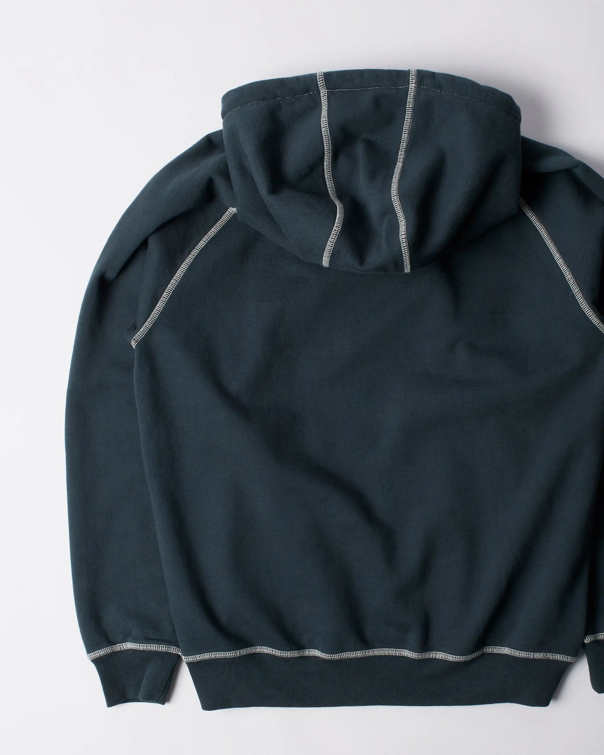 Back view of the byParra Circled Script Logo Hooded Sweatshirt in dark blue with white contrast stitching.