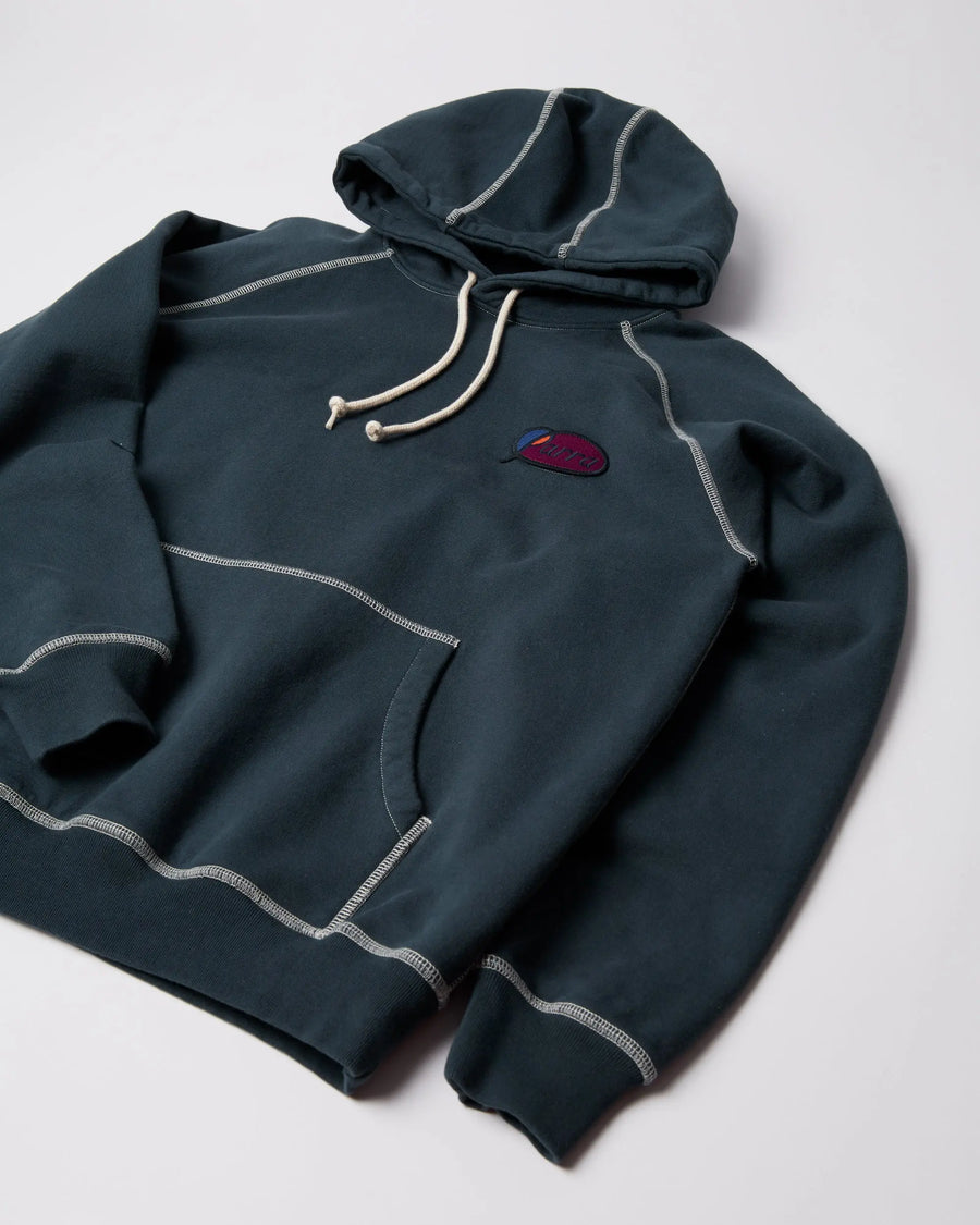 byParra Circled Script Logo Hooded Sweatshirt in dark blue with white contrast stitching.