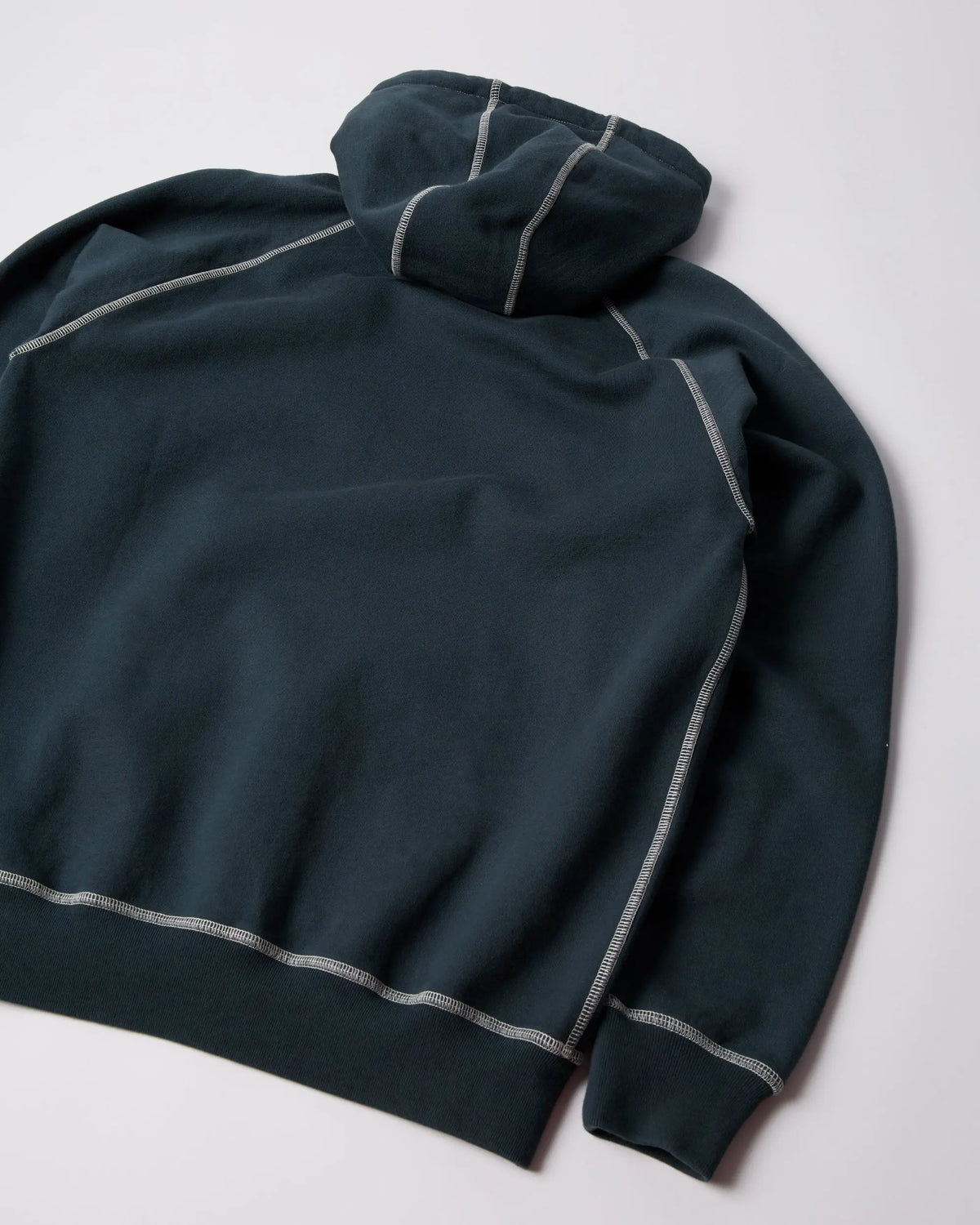Back of the byParra Circled Script Logo hooded sweatshirt in dark blue with white contrast stitching.