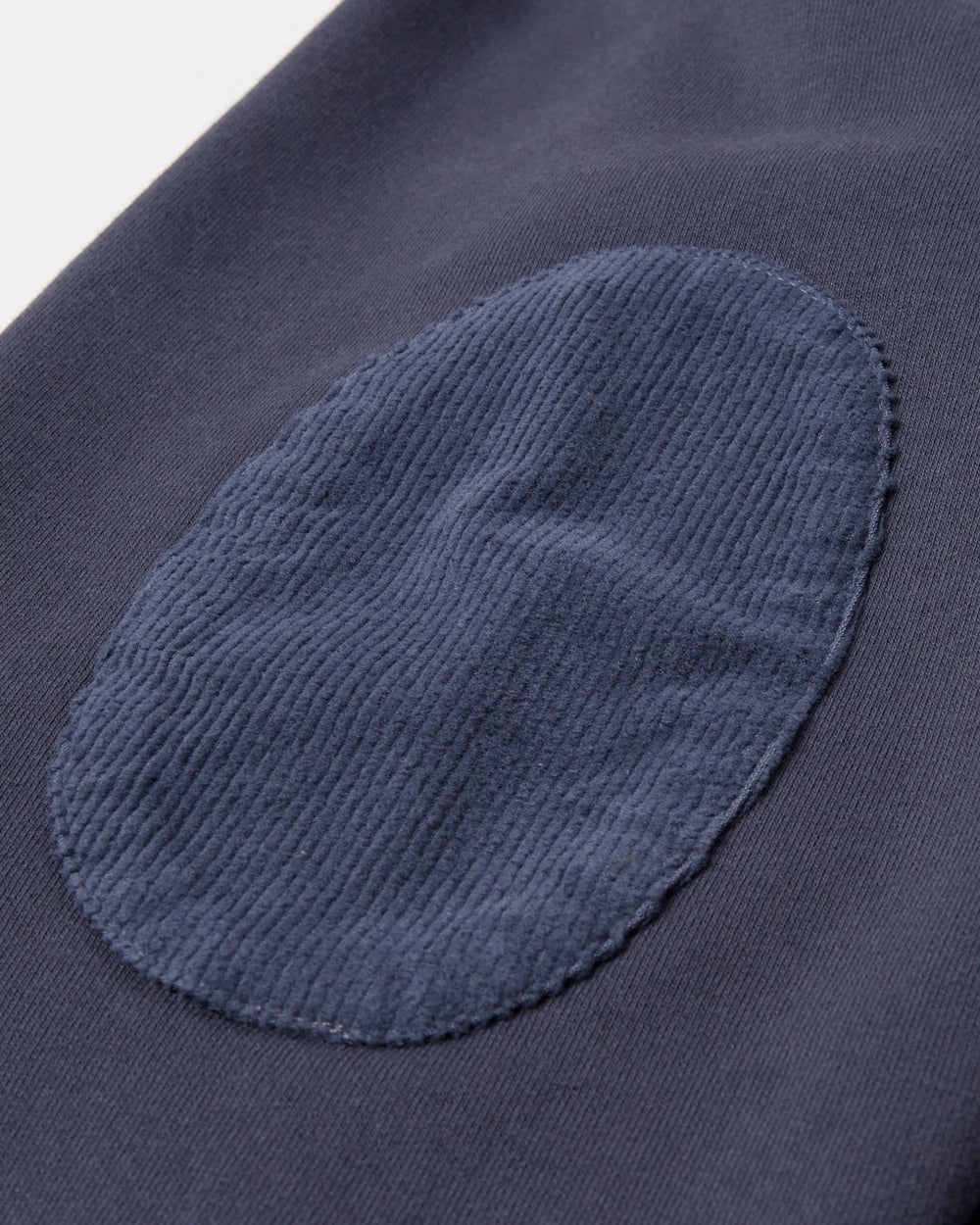 Ribbed corduroy elbow patch detail on the navy blue byParra Tired Champione crewneck sweatshirt.
