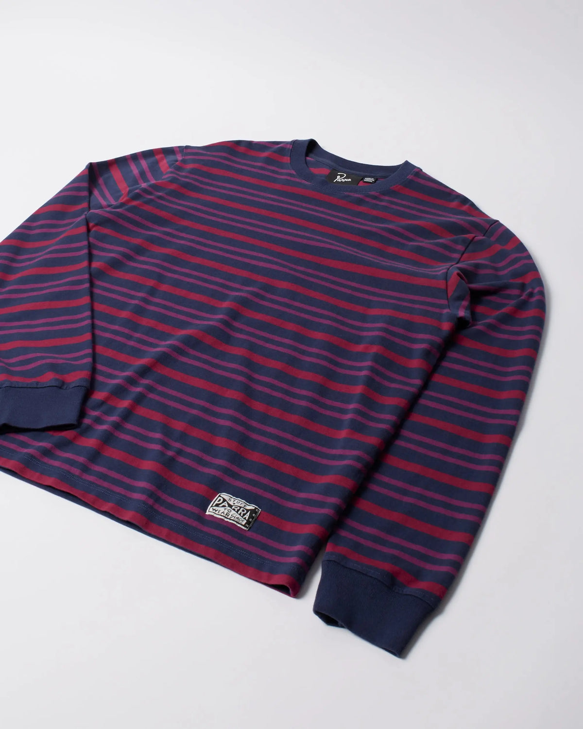 byParra 1992 long sleeve striped purple cotton t-shirt laid flat on a white background.