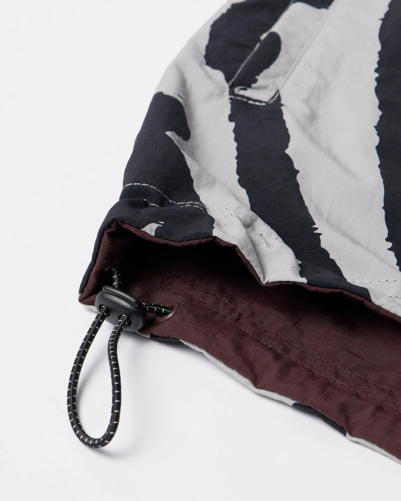 Close-up of the drawstring toggle hem on the byParra Freak Scene Reversible Track Top in grey.
