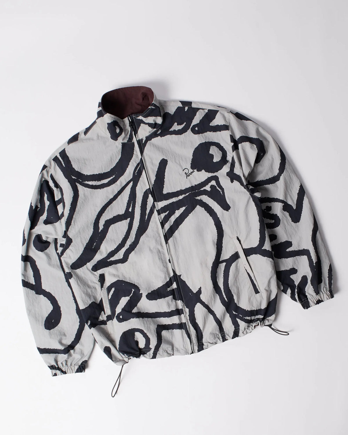 byParra Freak Scene reversible track top in grey featuring an abstract black pattern laid flat.