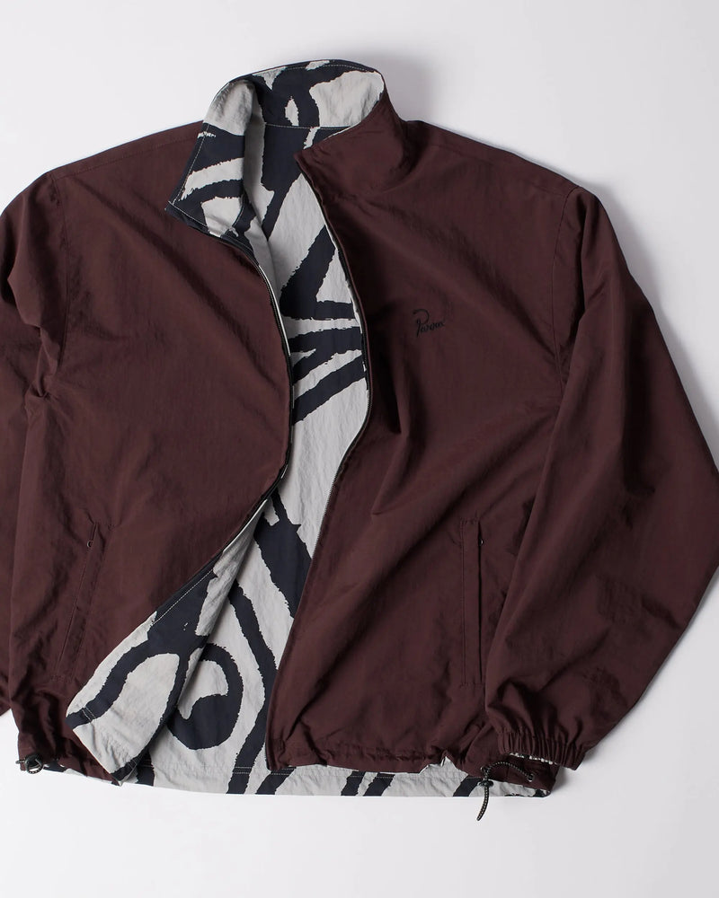 byParra Freak Scene Reversible Track Top unzipped, showing a brown shell and graphic patterned lining.