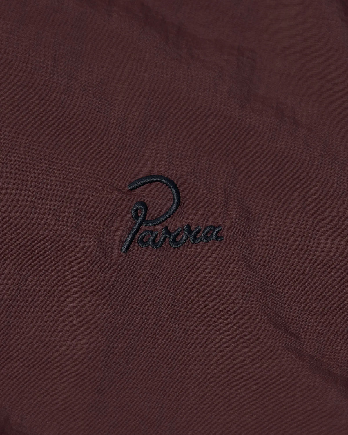 Embroidered black Parra script logo on the brown side of byParra Freak Scene Reversible Track Top.
