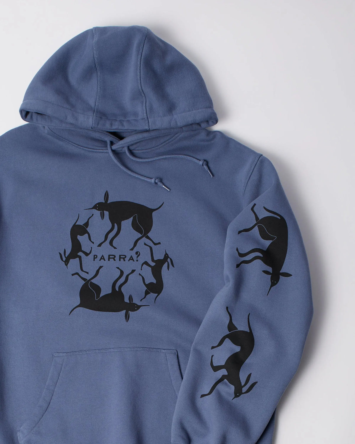Close-up of the black chest and sleeve graphics on a blue byParra hooded sweatshirt.