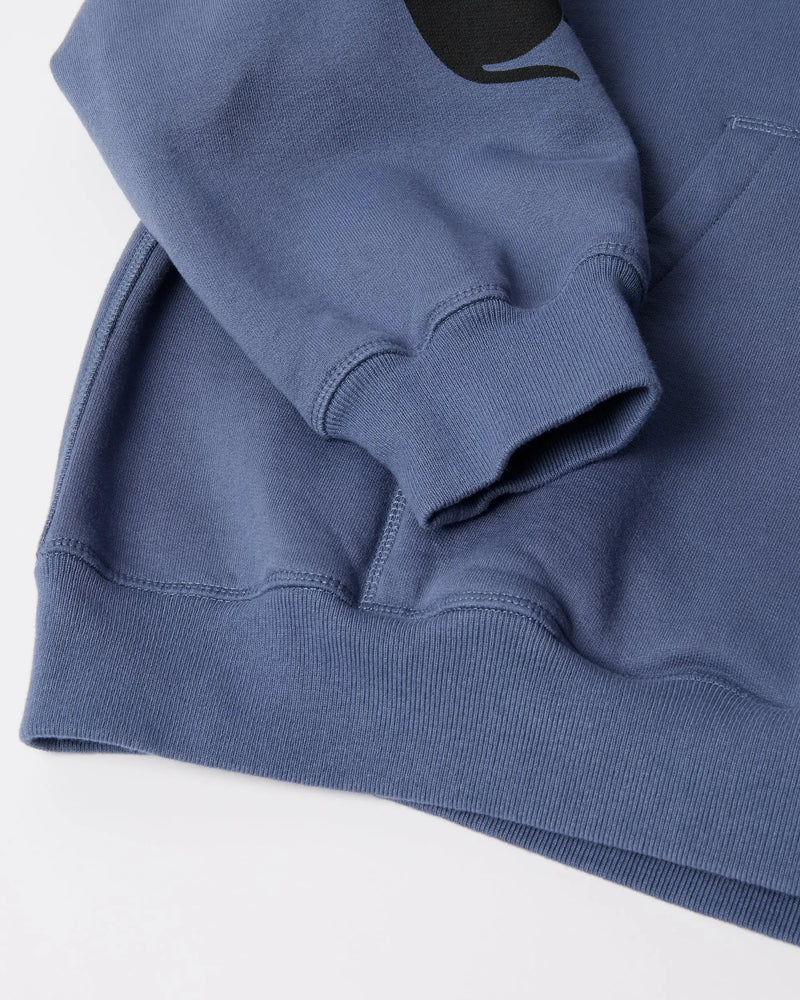 Close-up of the ribbed sleeve cuff and hem on the blue byParra Non Grand Cafe Hooded Sweatshirt.