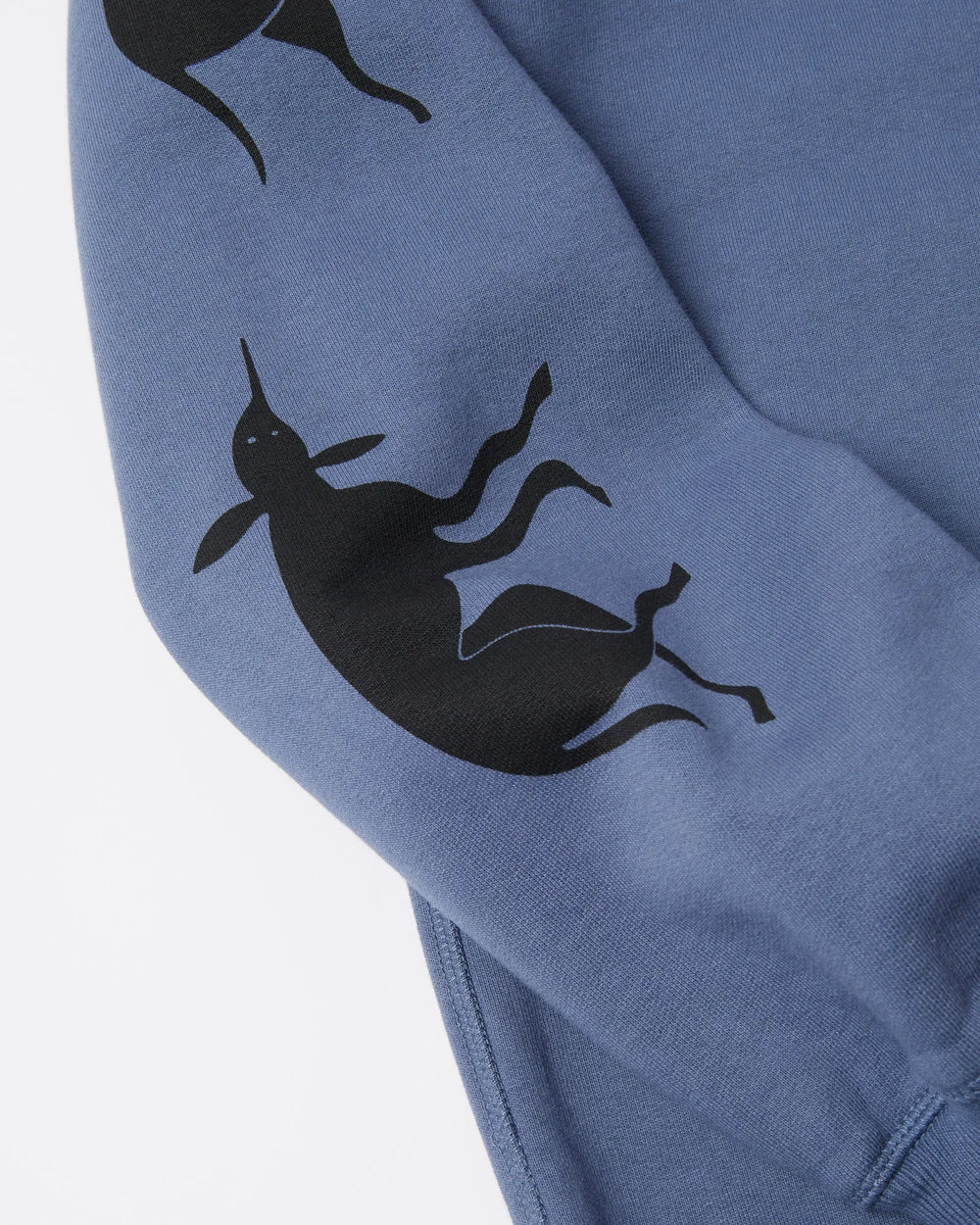 Black graphic silhouette print detail on the sleeve of a blue byParra hooded sweatshirt.