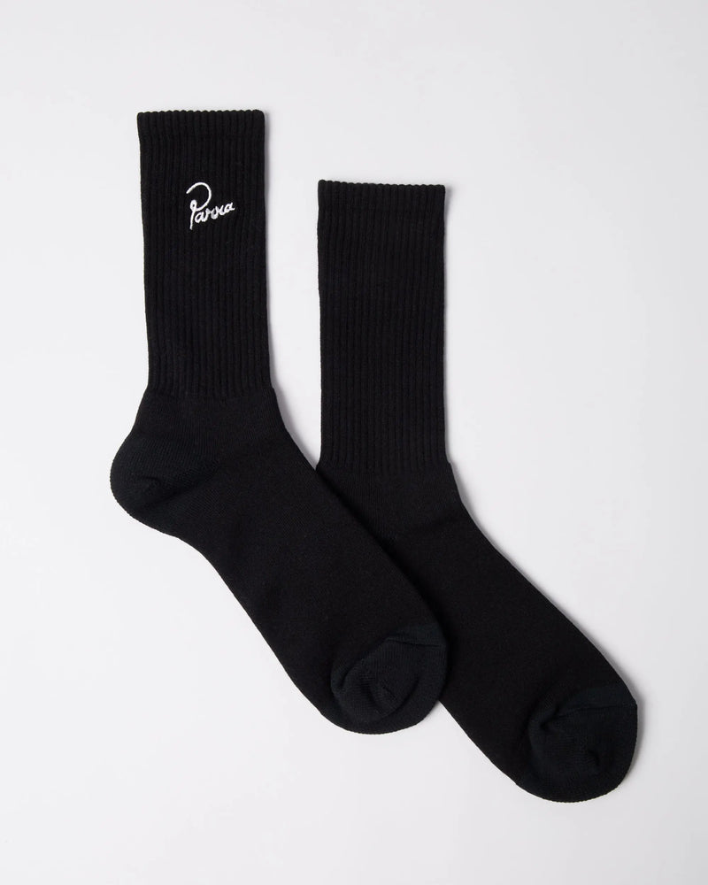 Black byParra Signature ribbed crew socks with white embroidered script logo on a white background.
