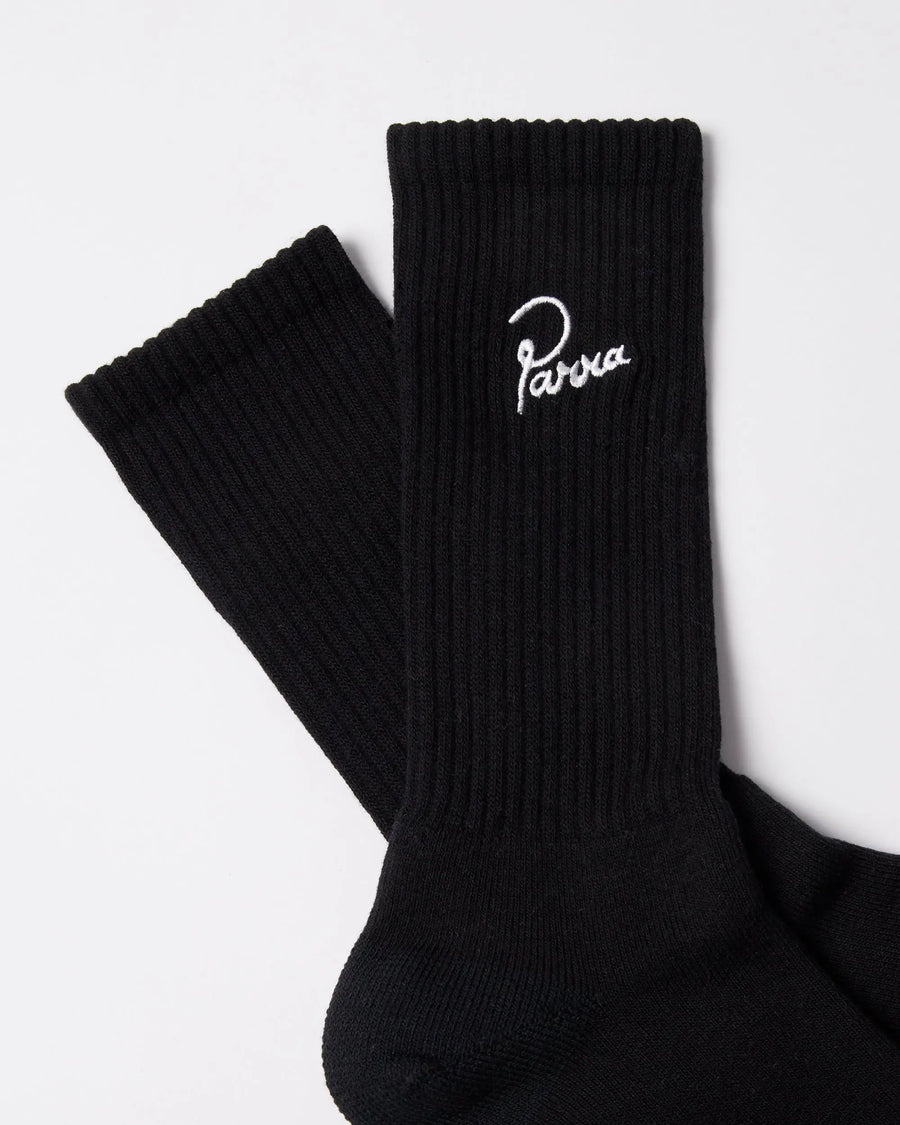 Detail view of black ribbed byParra Signature crew socks with white embroidered script logo.