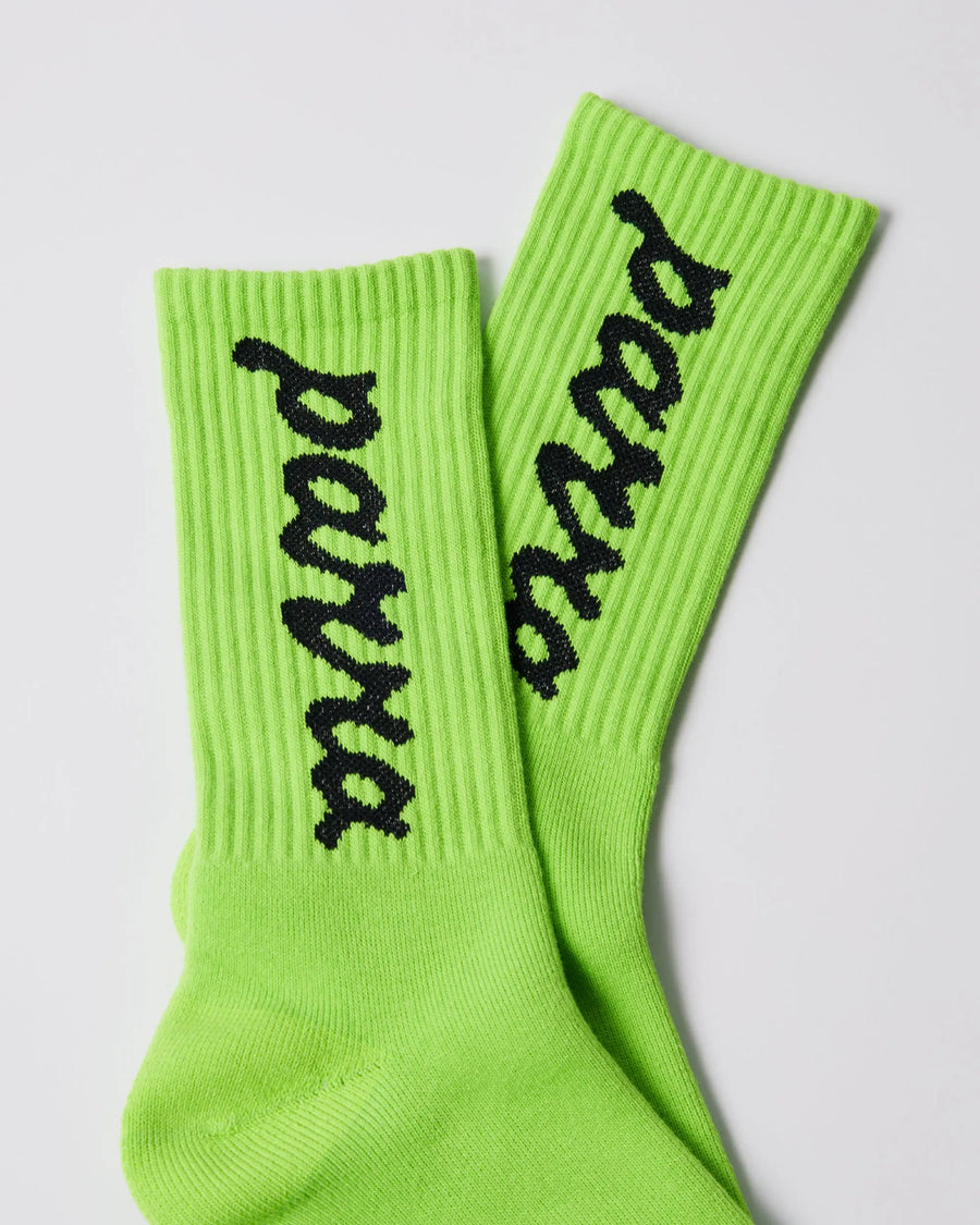 Detail of By Parra acid green ribbed crew socks with black lowercase script logo.
