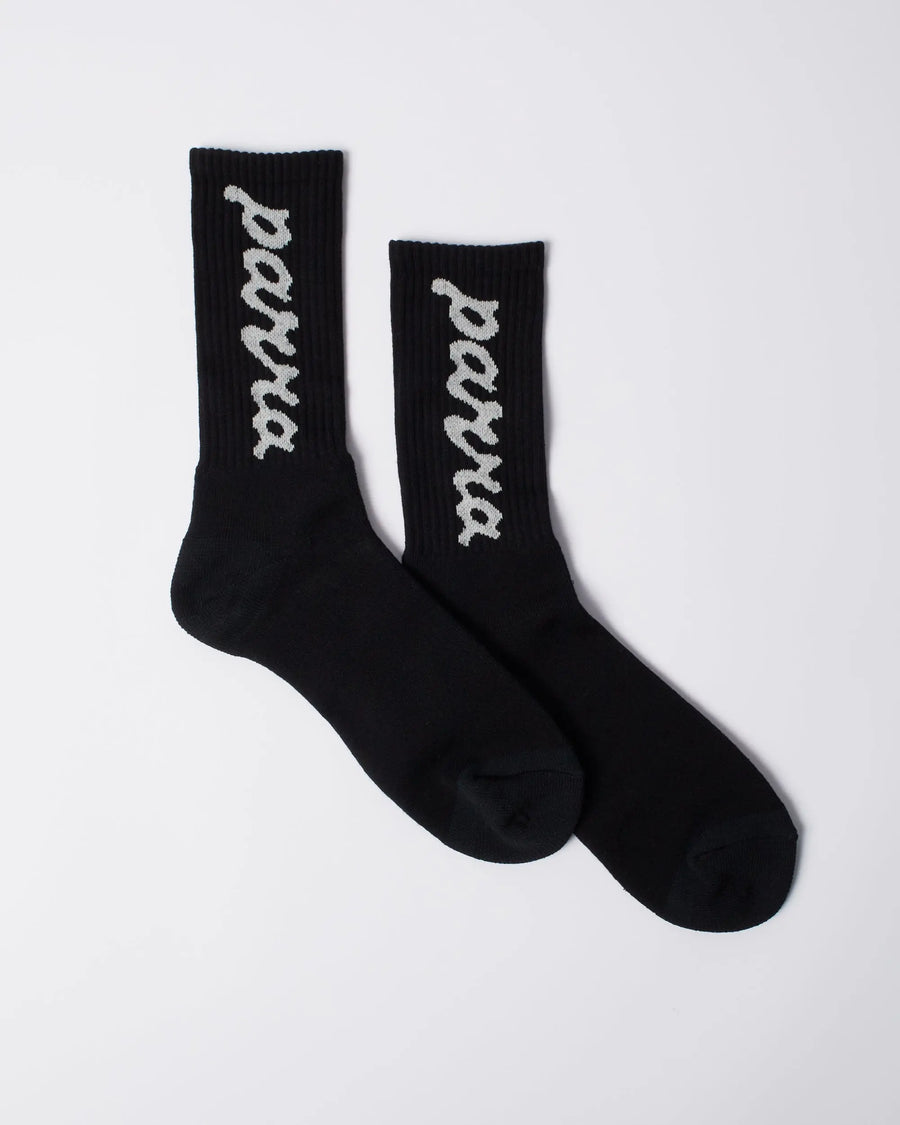 Black By Parra ribbed crew socks featuring a white lowercase script logo knit on the leg.