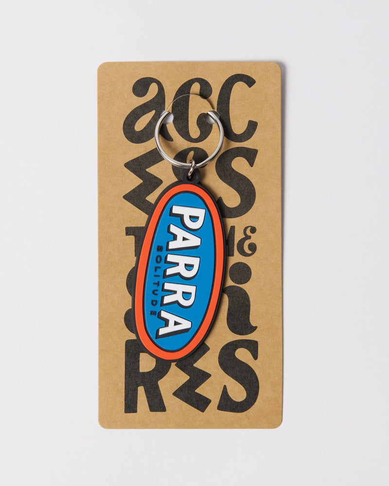 By Parra Lonely blue and orange oval rubber keychain displayed on cardboard backing.
