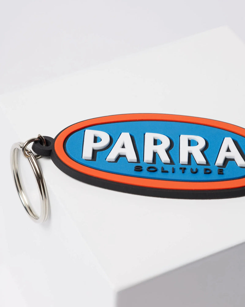 Close-up of By Parra Lonely blue rubber keychain with embossed Parra Solitude lettering.