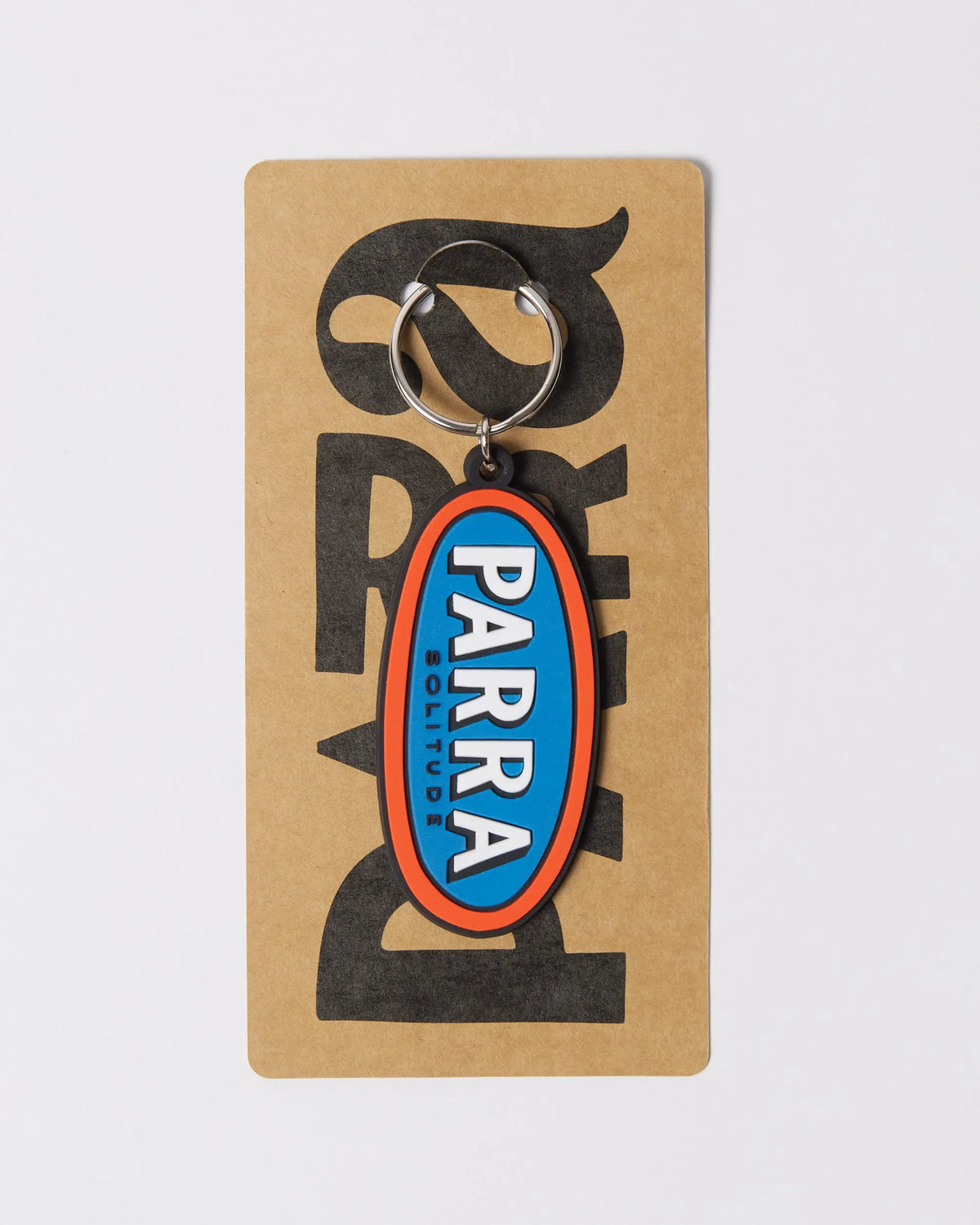By Parra Lonely rubber keychain in blue and orange, displayed on branded cardboard packaging.