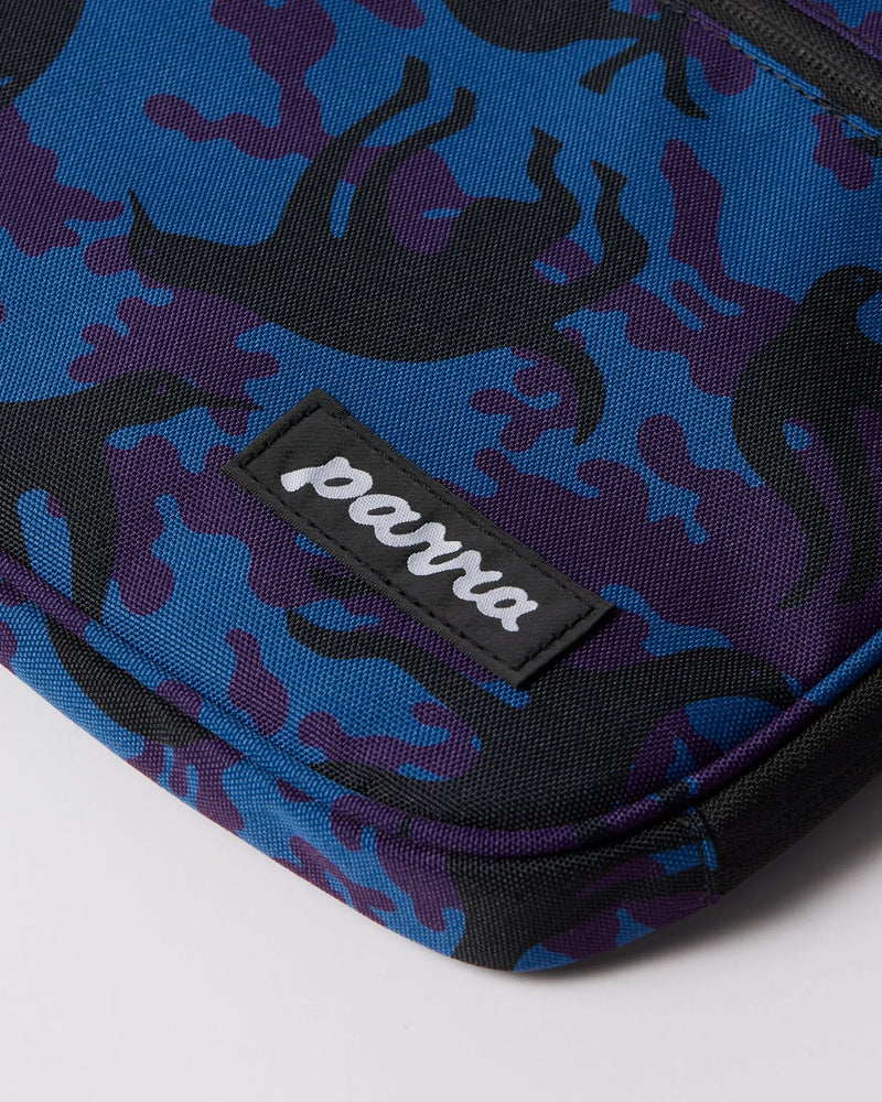 Close-up of the By Parra Purple Camo Beast laptop sleeve in blue, highlighting the stitched Parra logo patch.