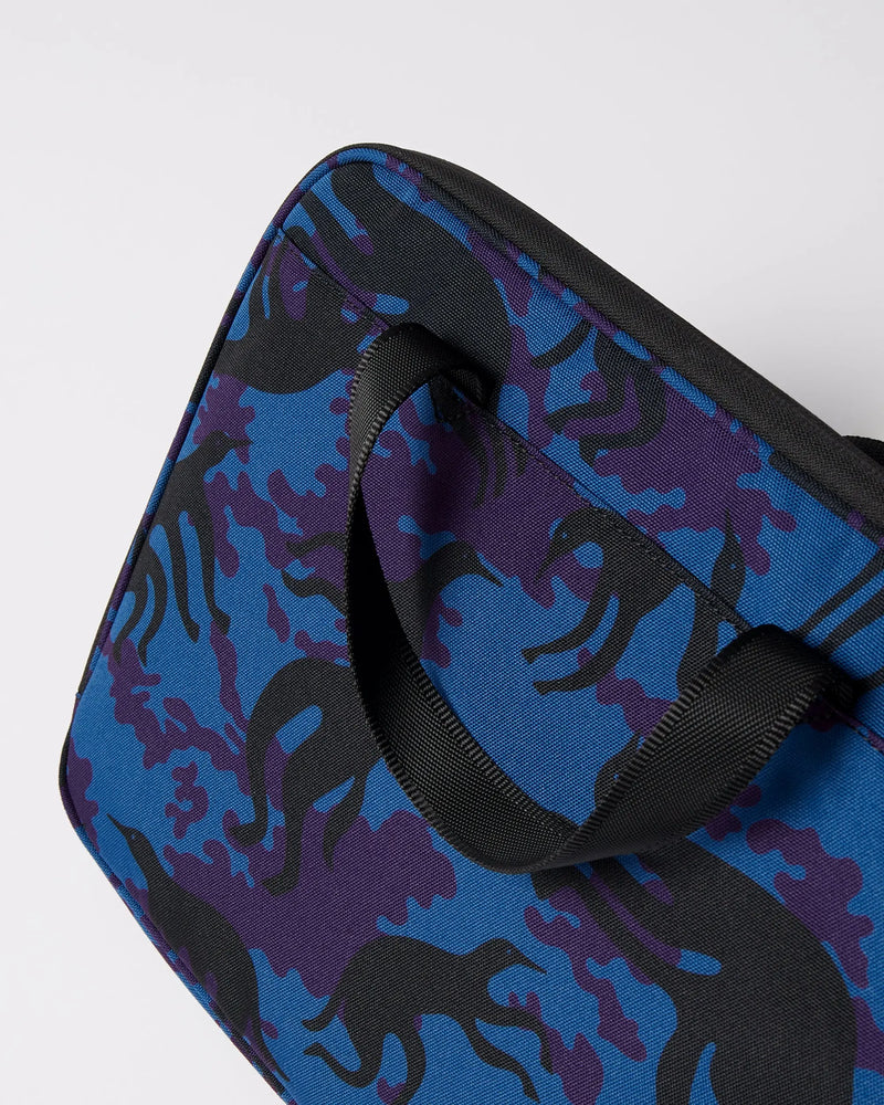 Close-up of By Parra Purple Camo Beast laptop sleeve in bleu showing the black carry handle and printed fabric.