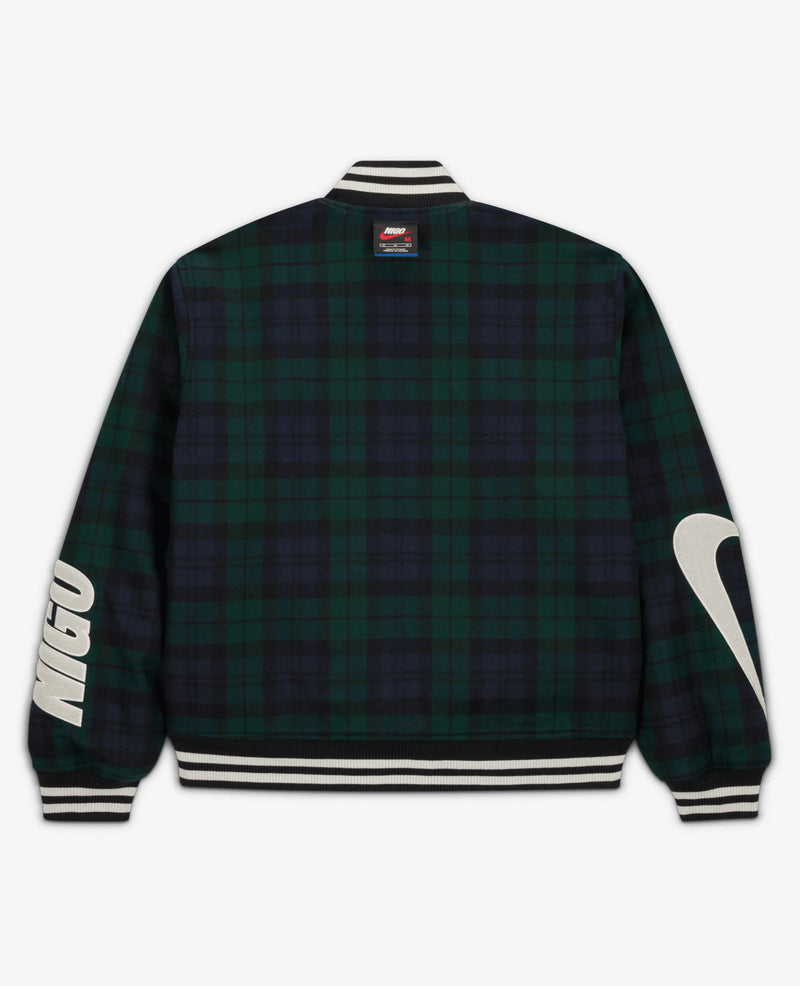 Back view of the Nike x NIGO NRG jacket in forest green plaid with bold sleeve patches.