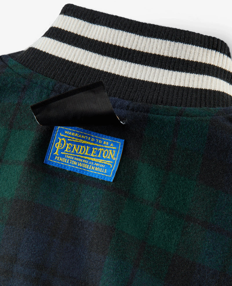 Blue Pendleton woven label on the Nike x NIGO green plaid wool jacket with striped ribbed collar.