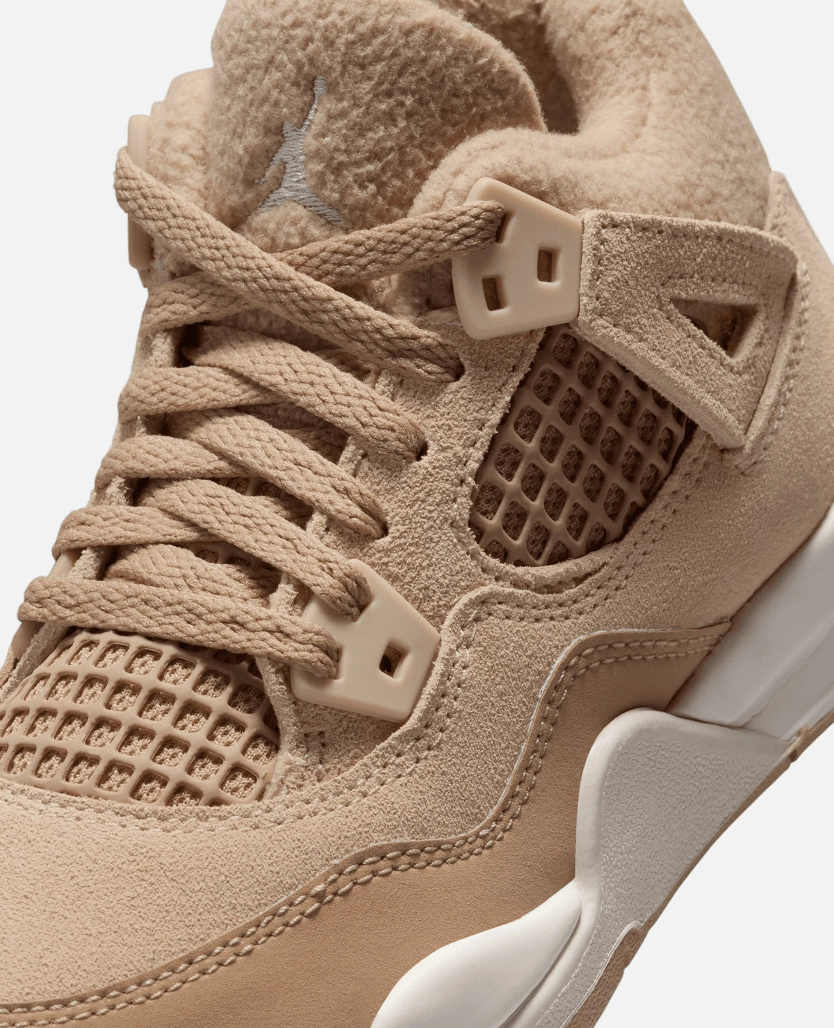 Close-up of the Nike Air Jordan 4 Retro Tex in Hemp, highlighting the fleece lining, suede upper, and lace cage.