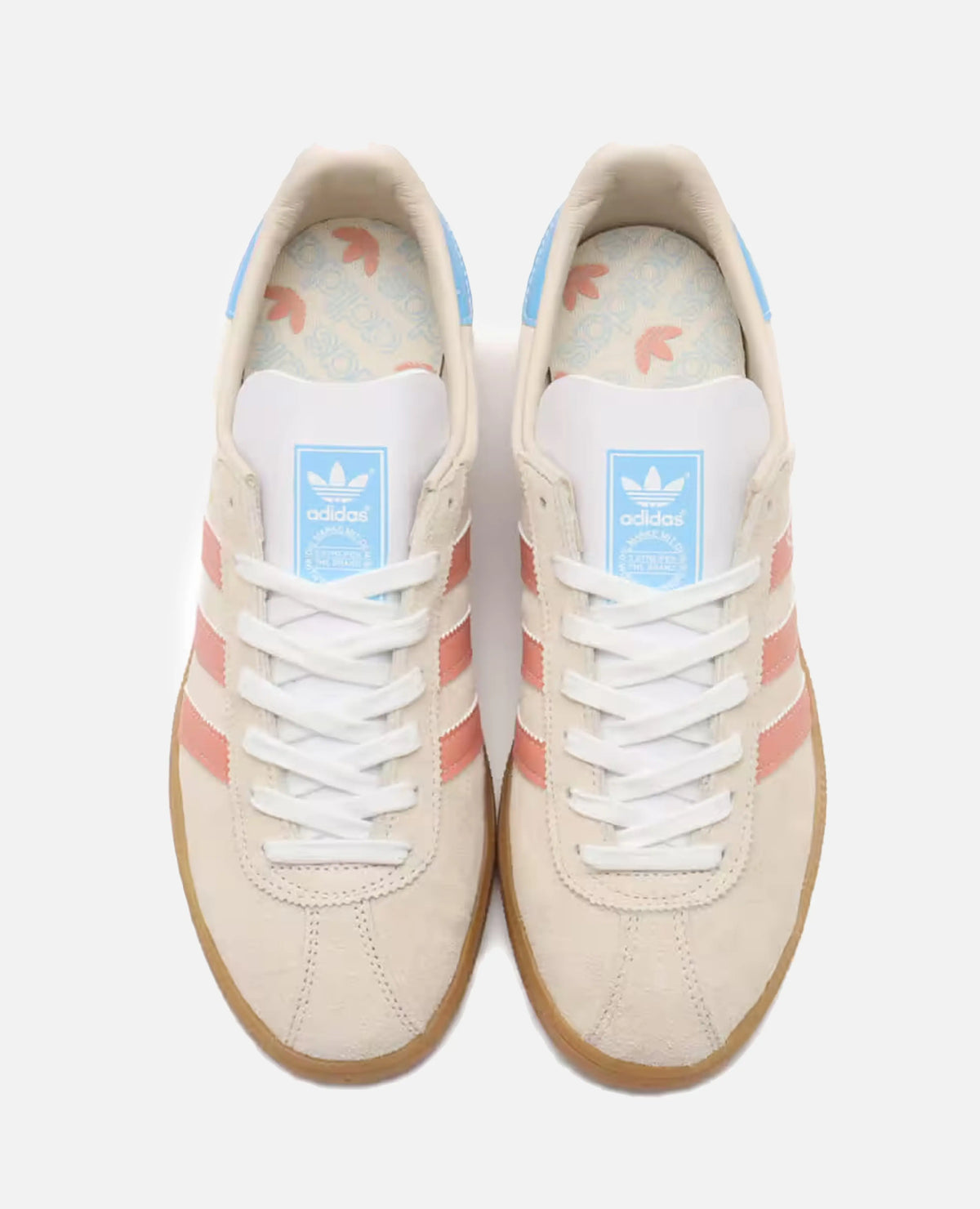 Top-down view of adidas Munchen 24 sneakers in Wonder White suede with Wonder Clay stripes and blue accents.