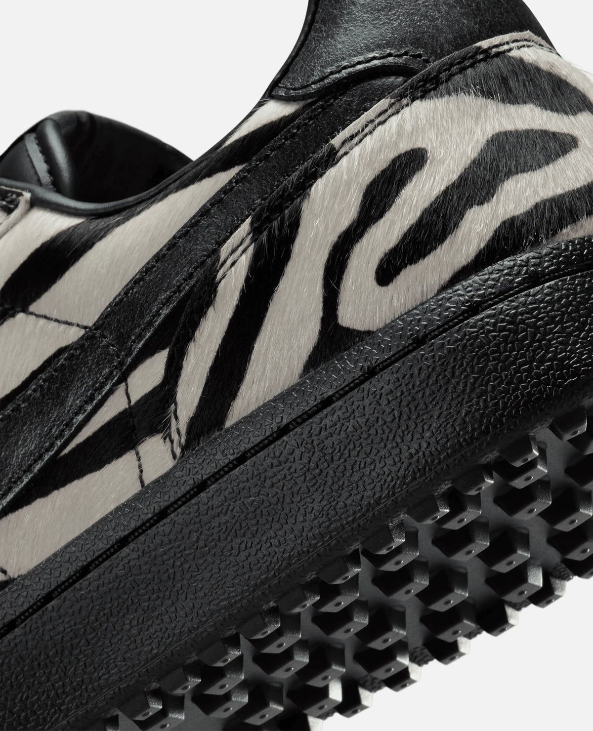 Close-up of zebra-print pony hair upper and black textured sole on the Nike Field General Premium sneaker.