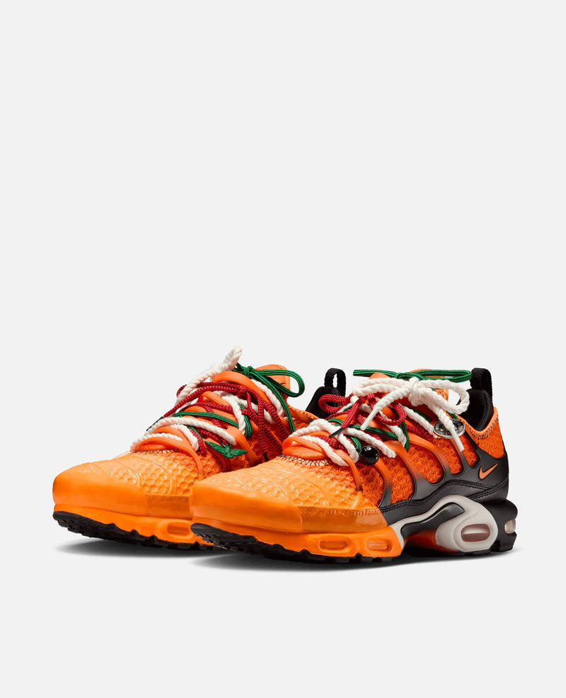 HOMECOMING x Nike Air Max Plus sneakers in safety orange with layered multicolor laces.