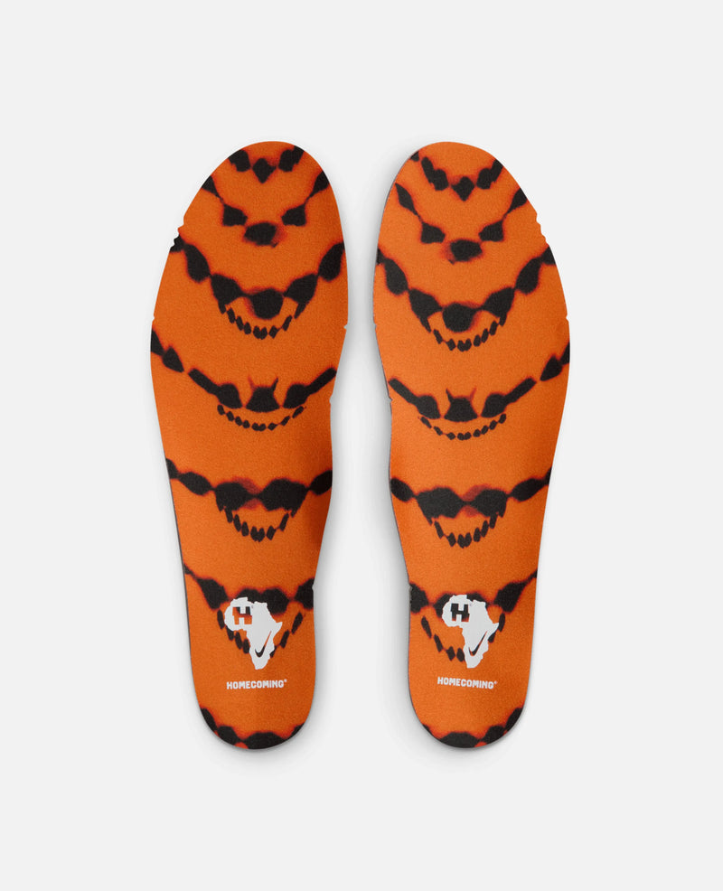 Printed orange and black insoles for the HOMECOMING x Nike Air Max Plus sneaker.