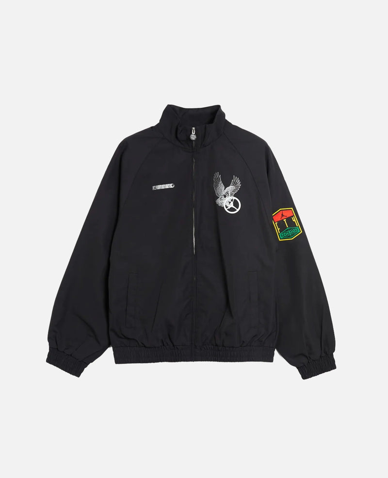 Nike Jordan x FTY men's black track jacket with graphic chest prints and sleeve patch.