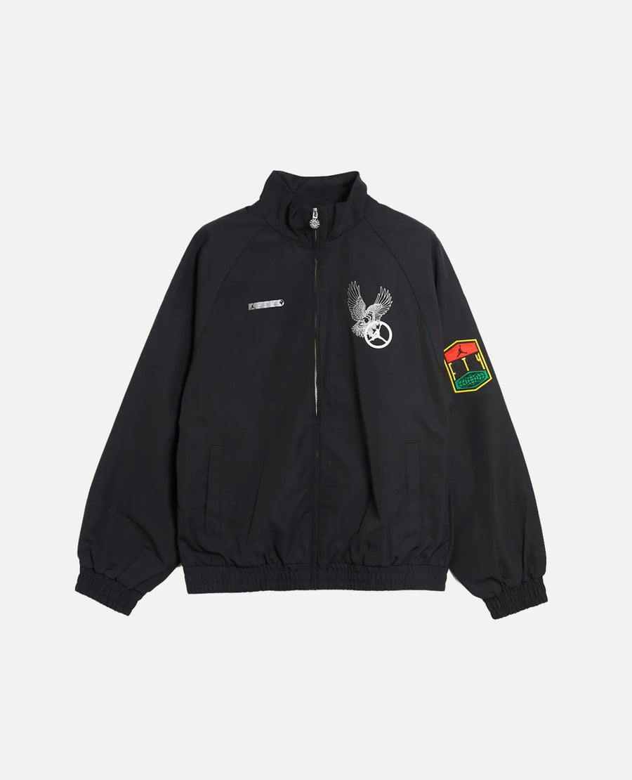 Nike Jordan x FTY men's black track jacket with graphic chest prints and sleeve patch.