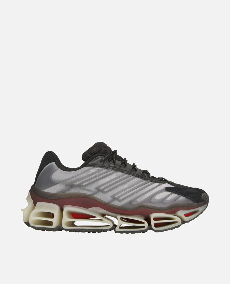 Side view of the Adidas Chavarria Megaride sneaker in black and grey with a sculpted Megaride sole.