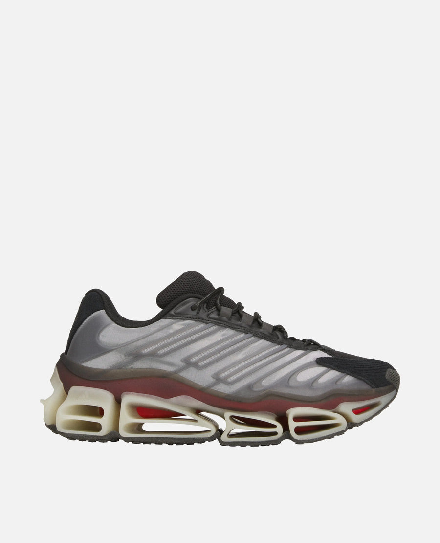 Side view of the Adidas Chavarria Megaride sneaker in black and grey with a sculpted Megaride sole.