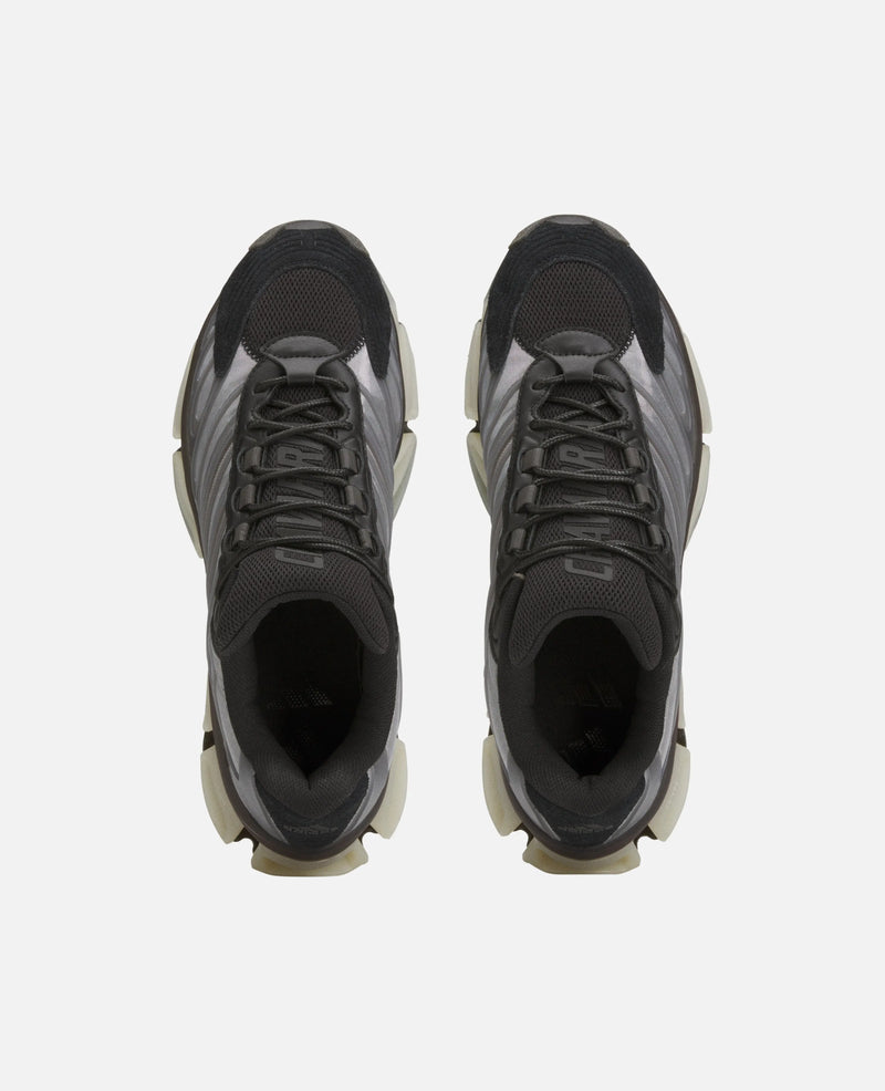 Top-down view of black adidas Chavarria Megaride sneakers with mesh uppers and chunky soles.