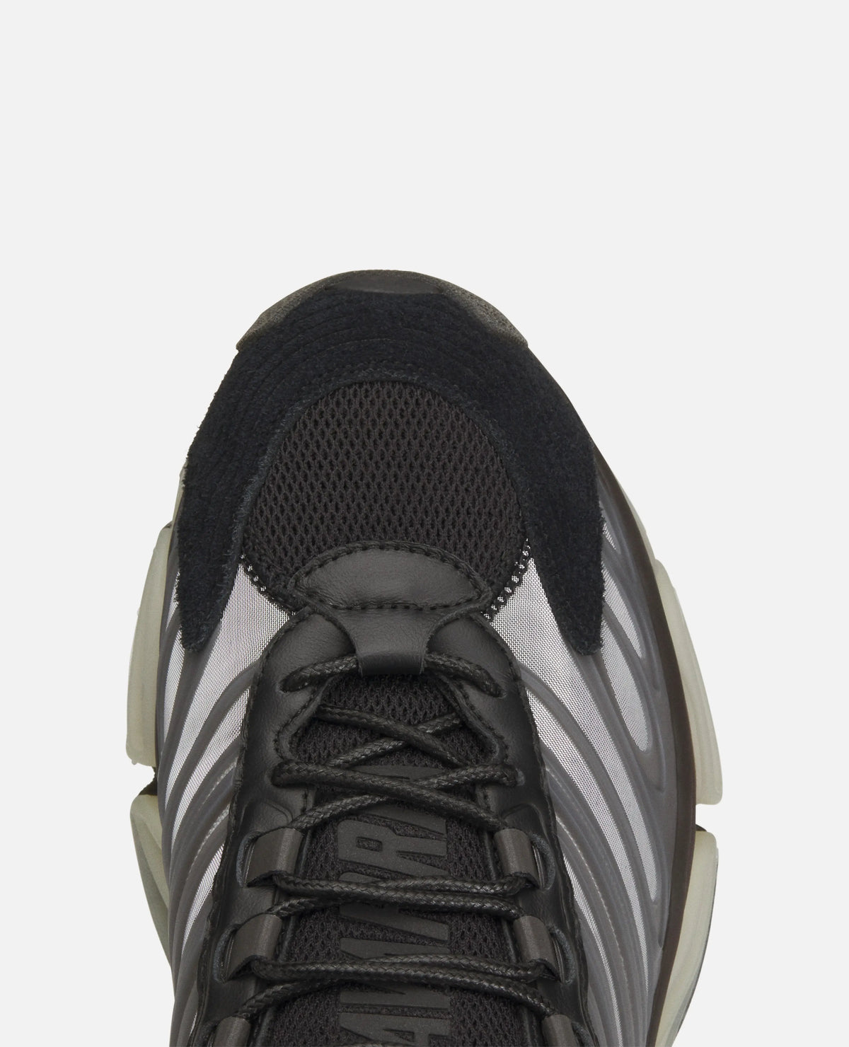 Top-down close-up of the black mesh toe box and laces on the Adidas Chavarria Megaride sneaker.
