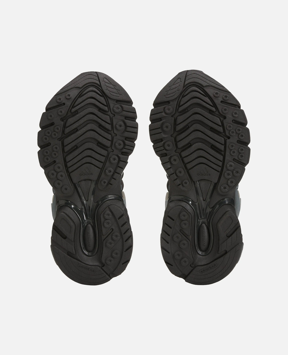 Black treaded rubber outsoles of the Adidas x Pharrell Williams Adistar Jellyfish sneakers.
