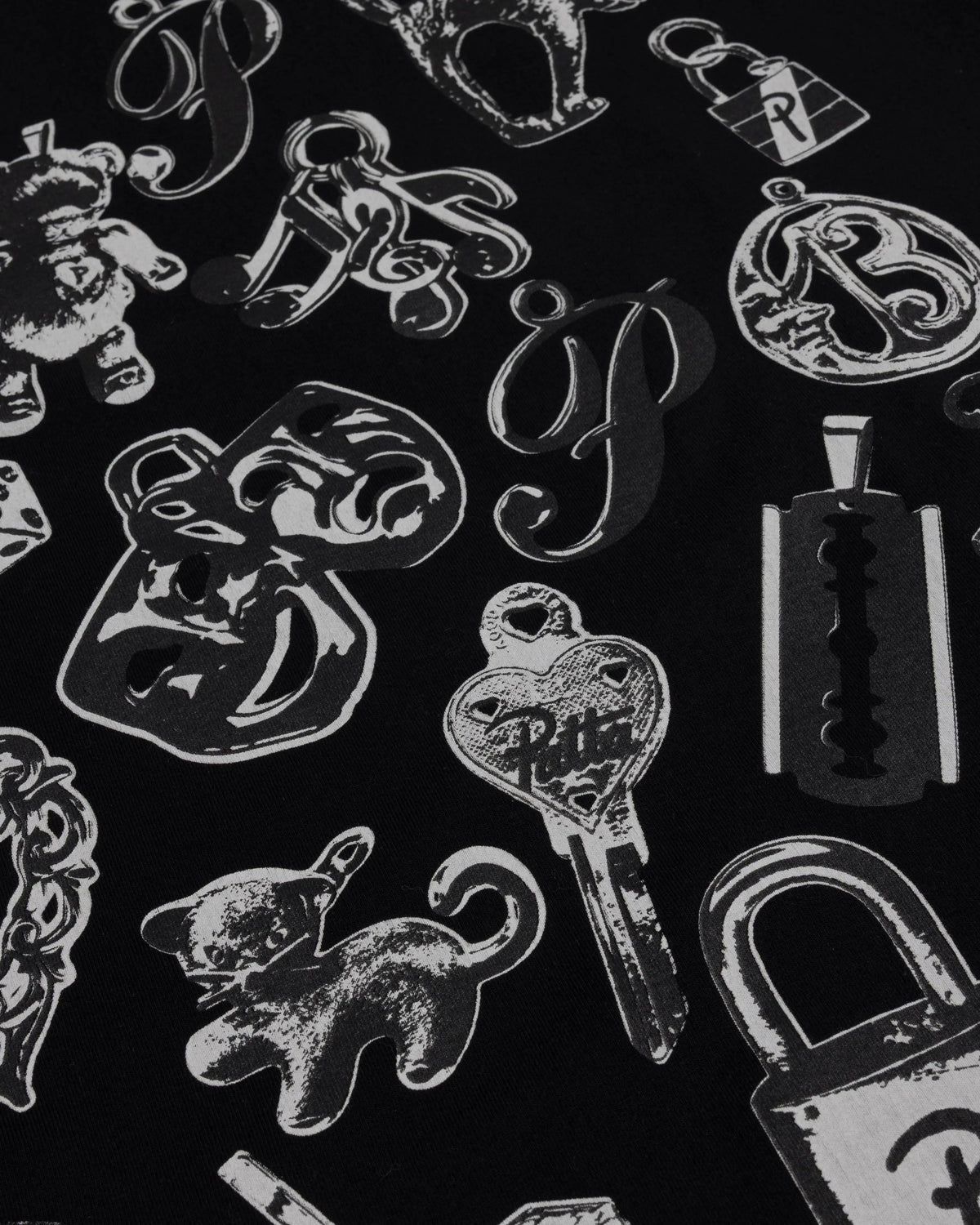 Close-up of the charms graphic print on the black Patta Charm T-Shirt.