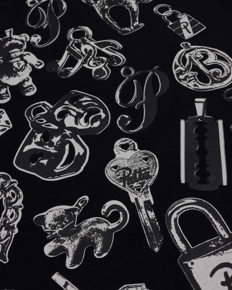 Close-up of the charms graphic print on the black Patta Charm T-Shirt.