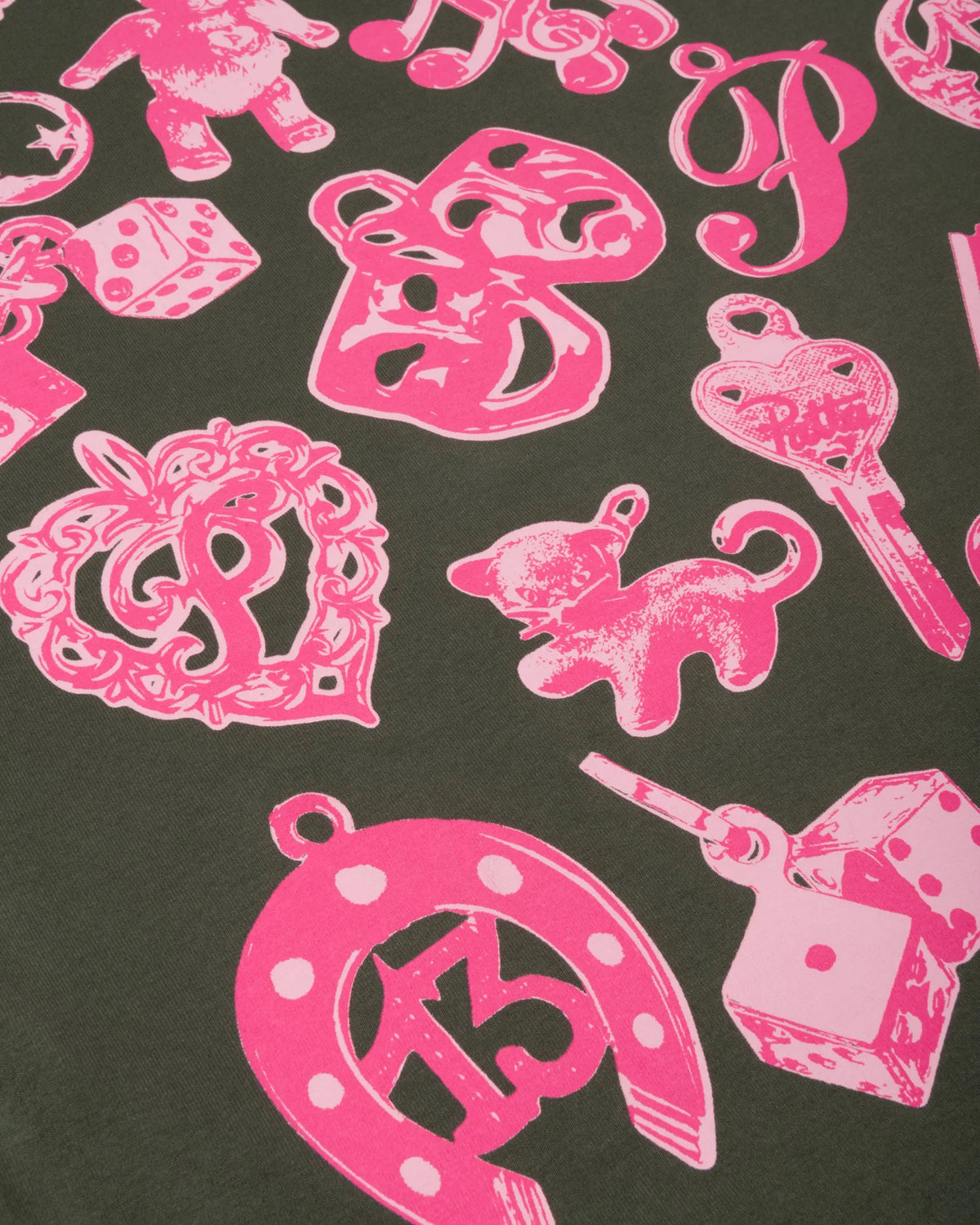 Close-up of pink charms graphic print on the Patta Charm T-Shirt in Climbing Ivy.