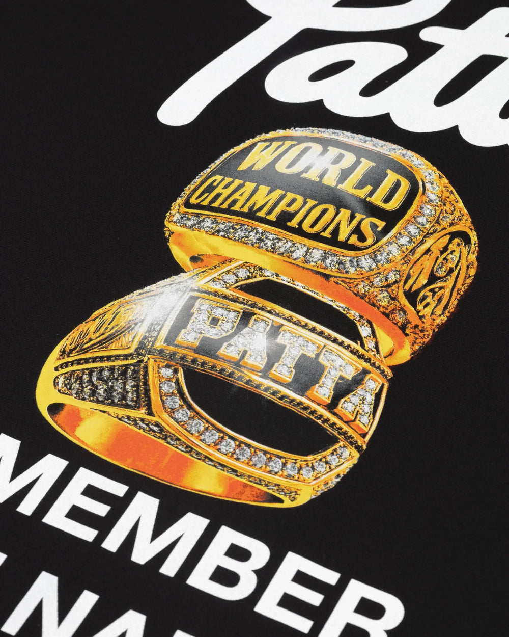 Detail of the gold championship rings graphic on the Patta Championship T-Shirt in Black.