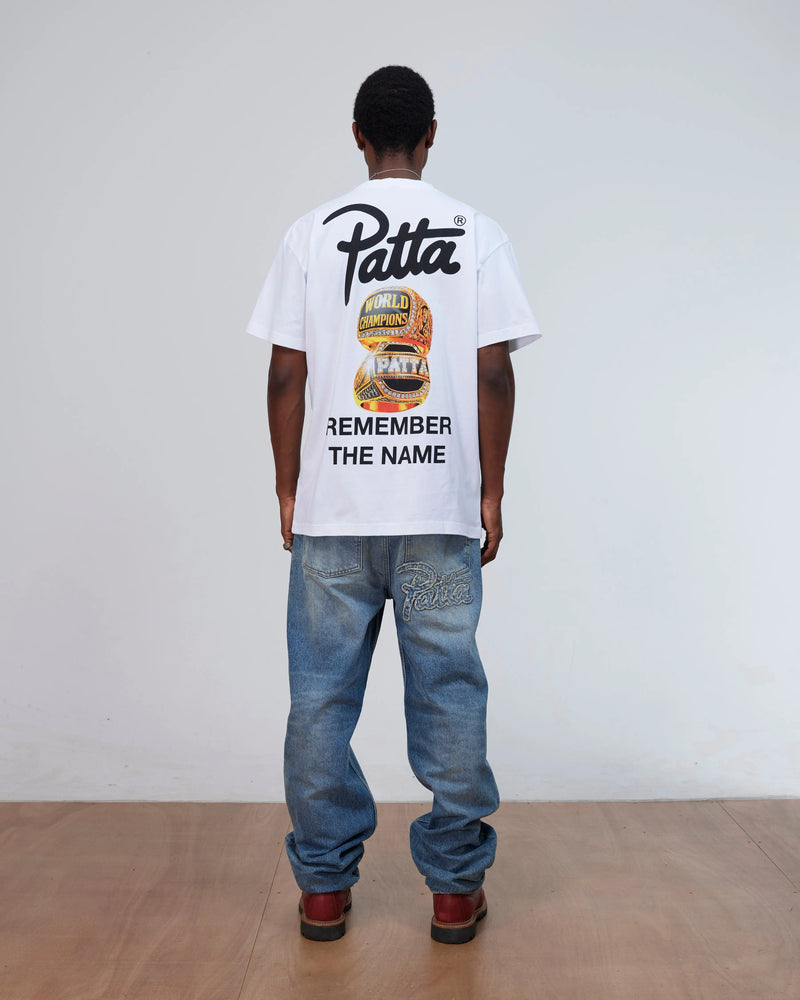 Back view of a model wearing the white Patta Championship T-Shirt with Remember The Name graphic.